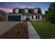 Charming home featuring a well-maintained lawn, black shutters, and a driveway leading to a two-car garage at 6330 E Irwin Pl, Centennial, CO 80112