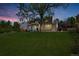 Beautiful front exterior of home featuring a lush green lawn and mature tree at 6330 E Irwin Pl, Centennial, CO 80112