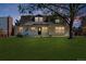 Attractive home with dormer windows, a lush green lawn, and mature landscaping at 6330 E Irwin Pl, Centennial, CO 80112