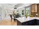Open concept kitchen featuring quartz countertops, updated appliances, and seamless transition to the dining and living areas at 6330 E Irwin Pl, Centennial, CO 80112