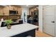 Beautiful kitchen showcasing updated appliances, sleek countertops, wooden cabinets, and views into the living room at 6330 E Irwin Pl, Centennial, CO 80112
