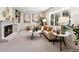 Cozy living room featuring a fireplace, large window, and a comfortable sofa with decorative pillows at 6330 E Irwin Pl, Centennial, CO 80112