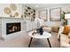 Charming living room featuring a fireplace, built-in shelves, and stylish decor with artwork at 6330 E Irwin Pl, Centennial, CO 80112