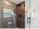 Contemporary shower with sleek gray tile, glass enclosure, and modern fixtures at 6330 E Irwin Pl, Centennial, CO 80112