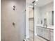 Modern bathroom featuring a glass shower, neutral tiling, and vanity with contemporary fixtures at 3140 Newfound Lake Rd, Berthoud, CO 80513