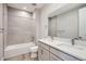 Modern bathroom with double vanity, sleek fixtures, and tiled shower over tub at 3140 Newfound Lake Rd, Berthoud, CO 80513