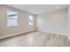 Bright bedroom with hardwood floors, neutral walls, and natural light from two windows at 3140 Newfound Lake Rd, Berthoud, CO 80513
