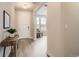 Bright entryway with hardwood floors, a white door, and views into the living room at 3140 Newfound Lake Rd, Berthoud, CO 80513