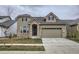 Charming two-story home featuring stone accents, a two-car garage, and well-maintained lawn at 3140 Newfound Lake Rd, Berthoud, CO 80513