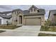 Charming two-story home featuring stone accents, a two-car garage, and well-maintained lawn at 3140 Newfound Lake Rd, Berthoud, CO 80513