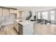 Open-concept kitchen featuring an island with a sink and seating, plus modern finishes, and an adjacent dining area at 3140 Newfound Lake Rd, Berthoud, CO 80513