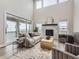 Bright living room featuring high ceilings, a fireplace, and access to outdoor balcony at 3140 Newfound Lake Rd, Berthoud, CO 80513