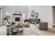 Modern living room with high ceilings, a fireplace, stylish furniture, and large windows at 3140 Newfound Lake Rd, Berthoud, CO 80513