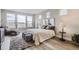 A cozy main bedroom featuring lots of natural light, a plush area rug and scenic views through the windows at 3140 Newfound Lake Rd, Berthoud, CO 80513