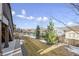 Backyard view featuring a grassy lawn, landscaping, neighborhood, and a wrought iron fence at 12597 W Big Horn Cir, Broomfield, CO 80021