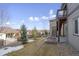 Backyard view featuring a grassy lawn, landscaping, wooden deck, and neighborhood views at 12597 W Big Horn Cir, Broomfield, CO 80021