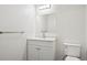 Clean bathroom with white vanity, toilet and a large mirror at 12597 W Big Horn Cir, Broomfield, CO 80021