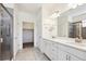 Bathroom with double vanity, walk-in shower, and large mirror at 12597 W Big Horn Cir, Broomfield, CO 80021