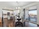 Dining area adjacent to kitchen and deck; features modern chandelier and deck access at 12597 W Big Horn Cir, Broomfield, CO 80021