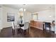 Bright dining area featuring hardwood floors, a glass-topped table, and custom built-in cabinetry at 12597 W Big Horn Cir, Broomfield, CO 80021