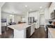 Modern kitchen features stainless appliances, white cabinets, an island, and seamless flow into the dining area at 12597 W Big Horn Cir, Broomfield, CO 80021