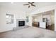 Open living room with kitchen view and fireplace at 12597 W Big Horn Cir, Broomfield, CO 80021