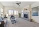 Inviting living room with vaulted ceilings, a cozy fireplace, and large windows offering scenic views of the neighborhood at 12597 W Big Horn Cir, Broomfield, CO 80021