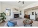 Bright living room with fireplace, plush carpet, large windows, and seamless flow into the modern kitchen at 12597 W Big Horn Cir, Broomfield, CO 80021