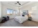 Bright main bedroom features a tray ceiling, large windows, and neutral decor at 12597 W Big Horn Cir, Broomfield, CO 80021