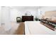 Staged bedroom featuring a bed, dresser, seating and bright window at 4363 N Raleigh St, Denver, CO 80212