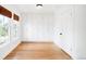 Bright bedroom features hardwood floors, built-in closet system, and large windows at 4363 N Raleigh St, Denver, CO 80212