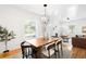 Bright dining room featuring a modern chandelier, hardwood floors and a large window, perfect for entertaining at 4363 N Raleigh St, Denver, CO 80212