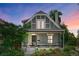 Charming two-story home featuring a welcoming front porch and upper balcony, complemented by lush landscaping at 4363 N Raleigh St, Denver, CO 80212