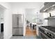 Modern kitchen featuring stainless steel appliances and open view to a bright dining room at 4363 N Raleigh St, Denver, CO 80212