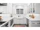 Bright kitchen with white cabinetry, farmhouse sink, subway tile backsplash, and modern appliances at 4363 N Raleigh St, Denver, CO 80212