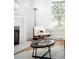 Cozy living room corner highlighting a decorative fireplace, chair, and view from the window at 4363 N Raleigh St, Denver, CO 80212