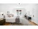 Bright main bedroom showcasing hardwood floors, a walkout balcony, and a modern media center at 4363 N Raleigh St, Denver, CO 80212