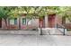 Modern brick townhouse with red door and small front yard at 2345 Walnut St # 28, Denver, CO 80205