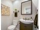 Updated powder room with dark vanity, white sink, and modern fixtures at 4291 W Lake N Cir, Littleton, CO 80123