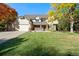 Two-story home with attached garage and landscaped lawn at 4291 W Lake N Cir, Littleton, CO 80123