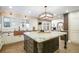 Open kitchen with large island, copper sink, and views to Gathering room at 4291 W Lake N Cir, Littleton, CO 80123