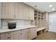 Bright laundry room with custom cabinetry, built-in bench, and washer/dryer at 4291 W Lake N Cir, Littleton, CO 80123