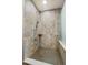 Spa-like shower with patterned tile, a rainfall shower head, and glass enclosure at 4291 W Lake N Cir, Littleton, CO 80123