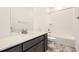 Modern bathroom featuring a dark vanity with a white countertop and a shower over bath at 4600 Thistle Dr, Brighton, CO 80601