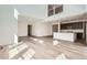 Open floor plan with plank flooring connecting the living area to the modern kitchen at 4600 Thistle Dr, Brighton, CO 80601