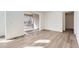 Modern living area featuring plank flooring and sliding glass door to the exterior deck at 4600 Thistle Dr, Brighton, CO 80601