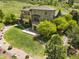 Beautiful backyard with a stone fireplace, lush landscaping, and covered patio at 10370 Grande Vista Ct, Lone Tree, CO 80124