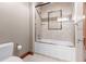 Bathroom with bathtub and shower featuring glass door and mosaic tile accent at 10370 Grande Vista Ct, Lone Tree, CO 80124