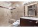 Bathroom featuring a tile shower with glass door and a vanity with a granite counter at 10370 Grande Vista Ct, Lone Tree, CO 80124