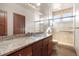 Spacious bathroom with granite countertop vanity and glass-enclosed shower with tile surround at 10370 Grande Vista Ct, Lone Tree, CO 80124